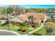 Expansive community clubhouse with beautiful landscaping, flagpole and manicured green lawn at 4955 Grist Mill Cir, New Port Richey, FL 34655