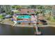 A community area offers a pool, cabana and pier extending over the lake at 4955 Grist Mill Cir, New Port Richey, FL 34655