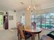 Cozy dining room featuring a charming chandelier, and a large window with lots of natural light at 4955 Grist Mill Cir, New Port Richey, FL 34655