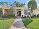 Charming single-story home featuring a well-maintained front yard with lush green grass and inviting walkway at 4955 Grist Mill Cir, New Port Richey, FL 34655