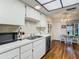 Bright kitchen showcasing white cabinets, stainless steel appliances, and a light-filled breakfast nook at 4955 Grist Mill Cir, New Port Richey, FL 34655