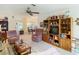 Spacious living room with plush armchairs, a ceiling fan, and access to the dining area at 4955 Grist Mill Cir, New Port Richey, FL 34655