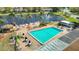 A beautiful community pool area offers a refreshing retreat with tables, chairs, and umbrellas at 4955 Grist Mill Cir, New Port Richey, FL 34655