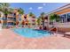 Community pool surrounded by lounge chairs, tropical plants, and residential buildings at 5000 Culbreath Key Way # 1-310, Tampa, FL 33611