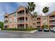 Multi-story condo building with screened patios, mature landscaping, and convenient parking spaces at 5000 Culbreath Key Way # 1-310, Tampa, FL 33611