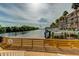 Picturesque dock view of calm water, condos with palm trees, boat slips, and serene water views at 5000 Culbreath Key Way # 1-310, Tampa, FL 33611
