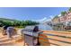 Outdoor grills with seating on a wooden dock overlooking calm waters and waterfront property at 5000 Culbreath Key Way # 1-310, Tampa, FL 33611
