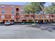 Multi-story condo building exterior featuring covered parking, private residential balconies, and lush green landscaping at 5000 Culbreath Key Way # 1-310, Tampa, FL 33611