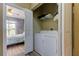 Convenient laundry closet including a washer and dryer set adjacent to the main bedroom at 5000 Culbreath Key Way # 1-310, Tampa, FL 33611