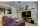 Cozy living room with a large TV, comfortable seating, and an open view into the kitchen at 5000 Culbreath Key Way # 1-310, Tampa, FL 33611