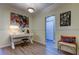 Bright living room featuring a desk area with decorative accents and light wood-look floors at 5000 Culbreath Key Way # 1-310, Tampa, FL 33611