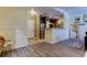 Open living space with hardwood floors, a kitchen view, and a comfortable sitting area at 5000 Culbreath Key Way # 1-310, Tampa, FL 33611
