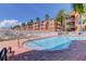 Inviting community pool with brick surround, resort-style lounge seating, and palm trees in a waterfront setting at 5000 Culbreath Key Way # 1-310, Tampa, FL 33611