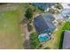 Birds-eye view of the property showcasing the backyard with screened-in pool and well-manicured lawn at 5140 Eclipse Ct, Spring Hill, FL 34607