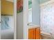 Bathroom sink, toilet, and shower with a flamingo themed shower curtain seen from doorway at 5140 Eclipse Ct, Spring Hill, FL 34607