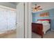 Bedroom and bathroom view with an ensuite and bed, ceiling fan, and stylish decor at 5140 Eclipse Ct, Spring Hill, FL 34607
