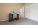 Bright bedroom features neutral walls, closet, and dark wood desk with turquoise patterned chair at 5140 Eclipse Ct, Spring Hill, FL 34607
