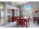 Formal dining room with a decorative china cabinet, large windows, and elegant furnishings at 5140 Eclipse Ct, Spring Hill, FL 34607