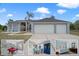 Charming single-story home with a well-manicured front yard, palm trees, and a spacious three-car garage at 5140 Eclipse Ct, Spring Hill, FL 34607