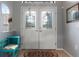 Elegant foyer with double doors with glass, tile floors, and a decorative rug at 5140 Eclipse Ct, Spring Hill, FL 34607
