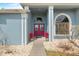 Charming entrance with a red double-door, complemented by elegant arched windows and vibrant potted plants at 5140 Eclipse Ct, Spring Hill, FL 34607