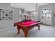 Open-concept game room with a pool table, leading into dining and foyer areas at 5140 Eclipse Ct, Spring Hill, FL 34607
