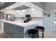 Well-lit kitchen with stainless steel appliances and bar seating at the counter at 5140 Eclipse Ct, Spring Hill, FL 34607