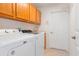 Functional laundry room featuring upper cabinets, a sink, and a washing machine next to a dryer at 5140 Eclipse Ct, Spring Hill, FL 34607