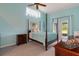 Calm main bedroom featuring a four-poster bed and access to the screened lanai at 5140 Eclipse Ct, Spring Hill, FL 34607