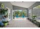 Covered patio with tile floors, doors to the pool and yard, and plants at 5140 Eclipse Ct, Spring Hill, FL 34607