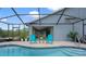 Enclosed pool with brick patio, and two outdoor chairs, showing easy access to the home's interior at 5140 Eclipse Ct, Spring Hill, FL 34607