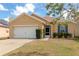 Charming single-Gathering home featuring a well-maintained lawn, neutral exterior, and a two-car garage at 5162 11Th E St, Bradenton, FL 34203