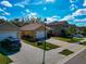 Street view of well-maintained homes with manicured lawns and driveways on a sunny day at 5162 11Th E St, Bradenton, FL 34203