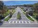 Gated community entrance with landscaped median and decorative stone pillars at 5210 Gato Del Sol Cir, Wesley Chapel, FL 33544