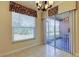 Dining area features tile floors, floral valance window treatment and sliding glass doors to the lanai at 5210 Gato Del Sol Cir, Wesley Chapel, FL 33544