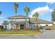 Lexington Oaks Golf Club entrance with palm trees and manicured landscaping at 5210 Gato Del Sol Cir, Wesley Chapel, FL 33544