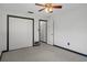 Neutral bedroom features include a ceiling fan, closet, and trim on the door and baseboards at 650 Jacaranda St, Dunedin, FL 34698