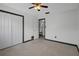 Bedroom features neutral carpet, closet, ceiling fan and access to the en-suite bathroom at 650 Jacaranda St, Dunedin, FL 34698