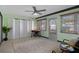 Inviting sun room featuring a ceiling fan, light green walls, and comfortable seating at 650 Jacaranda St, Dunedin, FL 34698