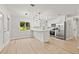 Modern kitchen with stainless steel appliances, white cabinets, and a breakfast bar area at 6918 12Th N St, St Petersburg, FL 33702