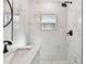 Modern bathroom featuring marble-like tiling, a rainfall shower head and a window for natural light at 708 15Th W Ave, Palmetto, FL 34221