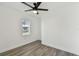 This bedroom features wood-look floors, a ceiling fan, and natural light from the window at 708 15Th W Ave, Palmetto, FL 34221