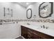 Bathroom with dual sink vanity, decorative mirrors, and modern fixtures at 709 Flamingo Dr, Apollo Beach, FL 33572