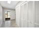 Bright foyer featuring tiled floors, bi-fold closet, view of screened front door, and access to the rest of the home at 709 Flamingo Dr, Apollo Beach, FL 33572