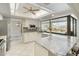 Modern kitchen with stainless steel appliances, white cabinets, granite countertops, and an island with seating at 709 Flamingo Dr, Apollo Beach, FL 33572