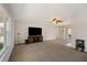 Spacious living room with carpet flooring, ceiling fan and access to the dining room at 709 Flamingo Dr, Apollo Beach, FL 33572