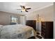 This main bedroom boasts a ceiling fan, and carpeted floors with an ensuite bathroom at 709 Flamingo Dr, Apollo Beach, FL 33572