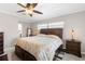 The main bedroom features a ceiling fan, carpeted floors, and an ensuite bathroom at 709 Flamingo Dr, Apollo Beach, FL 33572