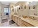 Bathroom featuring a double vanity with beige cabinets and framed mirrors at 7201 Hodgewood Ct, Tampa, FL 33614