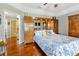 Spacious bedroom with wooden flooring, large bed, and a door to another room at 7201 Hodgewood Ct, Tampa, FL 33614